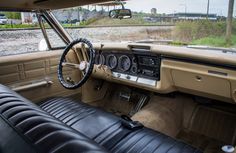 the interior of an old car with leather seats