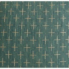 an upholstered fabric with small squares and crosses on the top, in teal green