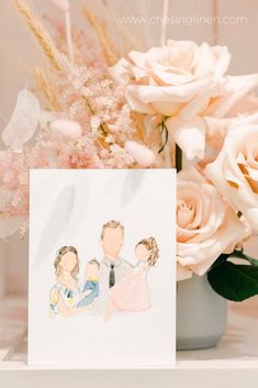 a card with an image of two people on it next to flowers and a vase