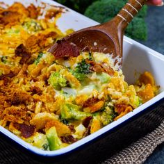 a casserole dish with broccoli, cheese and other toppings in it