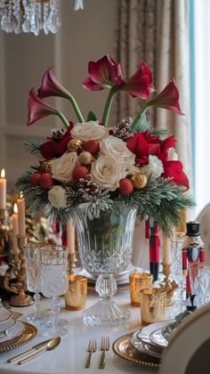 a centerpiece with flowers and candles on a table