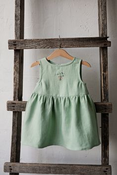 Smock dress is made of 100% soft medium weight linen.  Details: - Choose size and embroidery in the drop down menu - Colour: Green tea - Composition: 100% Oeko-Tex certified linen - Sleeveless  - Gathered waist  - White ribbon in the back - Medium weight linen - Linen care: machine wash gentle; tumble dry low, ironing optional - The price is for one smock dress, other pictured items are not included Sleeveless Linen Dress, Dress Linen, Dress For Girls, Girls Dresses Summer, Dress Girl, White Ribbon, Flower Girl Dress, Linen Apron, Smock Dress