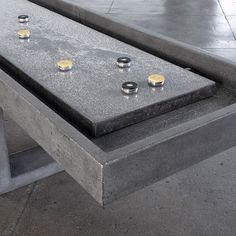 three candles sitting on top of a cement bench