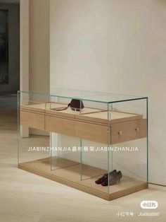 a pair of shoes sitting on top of a wooden table next to a glass display case