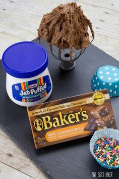 chocolate frosting, sprinkles, and other items on a slate board