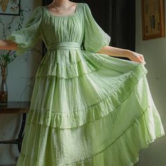 A fresh green forest that sparkles like a jewel in the sunlight. A dress with bright and refreshing colors. The sleeves are fluffy puff sleeves, and the skirt part has a tiered design that looks like layers. You will be fascinated by the way it sways softly and gracefully. 
 
 Size 
 
 S size
 
 Length: 120cm 
 
 Shoulder width: 35cm 
 Bust: 108cm 
 
 Sleeve length: 37cm 
 
 
 M size
 
 Length: 122cm 
 
 Shoulder width: 36cm 
 Bust: 112cm 
 
 Sleeve length: 38cm 
 
 
 
 
 Material 
 
 Lyocell Green Maxi Dress With Gathered Sleeves, Elegant Green Tiered Skirt Dress, Elegant Green Dress With Tiered Skirt, Green Square Neck Puff Sleeve Dress For Spring, Elegant Green Tiered Skirt Midi Dress, Elegant Green Midi Dress With Tiered Skirt, Fitted Green Tiered Dress, Elegant Green Tiered Midi Dress, Tiered Puff Sleeve Dress For Garden Party