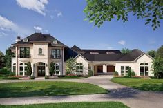 a large white house with lots of windows on the front and side of it, surrounded by lush green grass