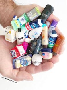 a person holding many different types of toothpaste in their hands