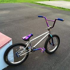 a purple and blue bike parked in a parking lot