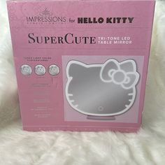 a hello kitty mirror in its box on a white furnishing area with the package