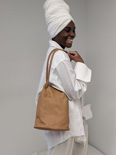 The Tube from Are Studio is a soft-form unlined shoulder bag that's a seasonless companion and a Na Nin beloved style The Tube bag features a drawstring-like closure, 1 infinity strap, exterior pocket - 3 wearable variations. Are Studio pieces are minimal and timeless, they serve as a clean slate for each person. We envision pairing Tube with our Charlie Blazer and a classic vintage top. 100% semi-aniline vegetable-tanned leather Made in Los Angeles Measurements: 12" length / 9" width / 4" base Everyday Minimalist Hobo Bucket Bag, Minimalist Bucket Bag With Detachable Strap, Everyday Pouch Shoulder Bag With Rolled Handles, Everyday Pouch Bag With Rolled Handles, Everyday Bags With Rolled Handles And Pouch Shape, On-the-go Bucket Bag With Rolled Handles, Everyday Minimalist Double Handle Bucket Bag, Minimalist Bucket Shoulder Bag For On-the-go, Modern Beige Bucket Bag With Rolled Handles