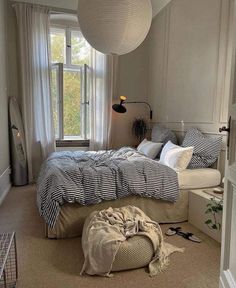 a bed room with a large bed and a window