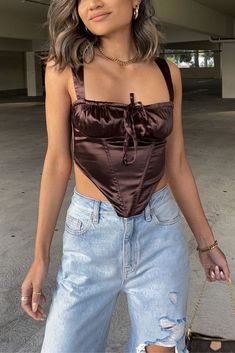 Bring on Spring in a modern bridgerton inspired outfit w/ a street style twist. Ft. a satin corset crop top & boyfriend jeans. #letsbepriceless #style #streetstyle #ootd #springfashion #springoutfit #womensfashion #womensoutfit #outfitideas #stylinginspo #casualoutfit #datenight #fashion #dreamcloset #chicoutfits #affordablestyle #teenoutfits #simpleoutfits #casualfashion #softgirlaesthetic #cottagecore #springtrends #trendyoutfits #mothersday #springdress #90sfashion #aestheticoutfits Flirty Fitted Satin Tops, Satin Crop Top With Boned Bodice For Party, Party Satin Crop Top With Boned Bodice, Sleeveless Satin Corset With Built-in Bra, Flirty Sleeveless Satin Tops, Sleeveless Satin Top With Boned Bodice, Satin Camisole Crop Top For Night Out, Fitted Satin Tops For Date Night, Satin Tops With Boned Bodice For Night Out