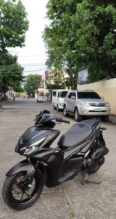 a black motorcycle parked on the side of a road