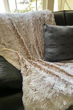 Faux Fox Fur Throw in Foxy Beach spread over a black leather couch. Throw pillow in Outback Brown vegan leather leans against the throw. Leather Throw Pillow, Leather Throw Pillows, Fur Texture, Beach Throw, Arctic Fox