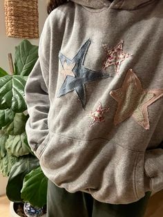 a person wearing a sweatshirt with stars on it