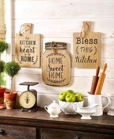 kitchen wall decor with mason jars, apples and other items on top of a dresser