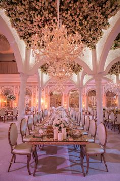 an elaborate dining room with chandeliers and tables set for formal dinner or party