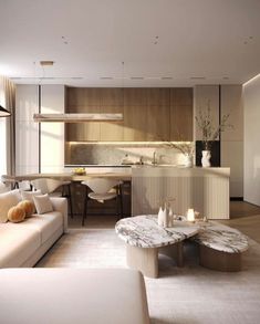 a living room filled with furniture next to a kitchen and dining table in front of a window