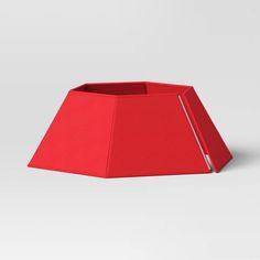 a red lamp shade sitting on top of a table