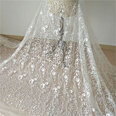 "This stunning Lace Fabric design piece has soft hand feel, It's perfect for weddings, bridal parties, and any events. Shop our large inventory of bridal fabrics. ☆PRODUCT DESCRIPTION : This gorgeous fabric is made on a sheer base with a beautiful flower embroidery throughout. The fabric width is approximately 51\" (130cm) Wide. Color: off-white or beige as in picture Material: Rayon, Polyester，Sequins ☆ PURCHASING INFORMATION: This fabric is sold by the yard and each Qty you enter will represen Wedding Dress Embroidery, Elegant Bridal Dress, Bridal Lace Fabric, Dress Embroidery, Embroidered Lace Fabric, Bridal Fabric, Ladies Gown, Flower Lace, Wedding Fabric