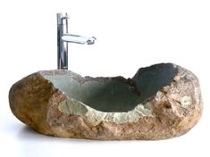 a stone sink with a faucet on it