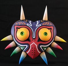 a colorful mask with horns and spikes on it