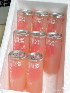 six cans of blue bellue are in a plastic container