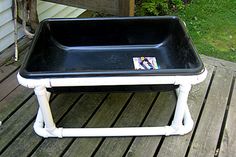 a black and white tray sitting on top of a wooden deck