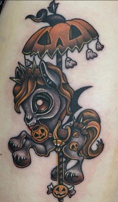 an image of a tattoo on the back of a woman's thigh with a cat and umbrella