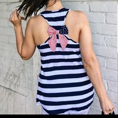 Super Cute Red, White And Blue Racer Back Tank Top Is Decorated With An Adorable Bow At The Gathering Of The Back. It Is A True To Size Fit And Very Flattering On Any Shape. Patriotic Blue Tops For Beach, Blue Patriotic Sleeveless Top, Blue Sleeveless Patriotic Tops, Racer Back, The Gathering, Red White And Blue, Red White, Super Cute, Tank Top