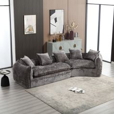 a living room with a sectional couch and rug on the floor in front of it