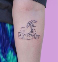 a woman's arm with a tattoo on it that has an image of food and drinks