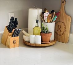 kitchen utensils and cutting boards are arranged on the counter