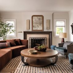 a living room with two couches and a coffee table in front of a fireplace