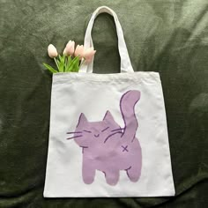 a bag with a cat drawn on it and flowers in the bottom right hand corner