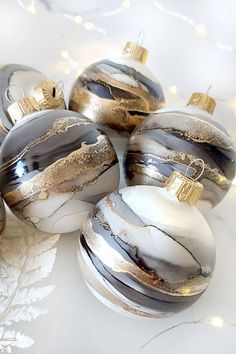 christmas ornaments with gold and silver designs on them