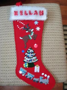 a red christmas stocking with reindeer and train on it