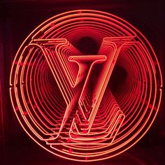 a red neon sign with the letter z on it's side in front of a dark background