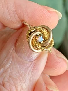 This wonderful ring started life as a Victorian-era stick pin, which I converted into a ring. It's crafted of 10K yellow gold with a central opal, and it's in the classic love-knot motif. The opal in the center may be small, but it's a richly colored and beautiful one. The ring is an easily resized 4.75 in 10K gold. You can see the 10k stamp on the exterior of the band in one photo, which can professionally buffed out if you don't want it visible. Free shipping in the US. If you live elsewhere, Victorian Style Hallmarked Opal Ring In Yellow Gold, Victorian 14k Gold Opal Ring For Anniversary, Victorian Gold Opal Ring Gift, Antique 14k Gold Opal Ring For Anniversary, Antique Gold Opal Ring For Anniversary, Vintage Yellow Gold Opal Ring Birthstone, Victorian 14k Gold Opal Ring Gift, Antique Yellow Gold Opal Ring, Antique Yellow Gold Opal Ring Gift