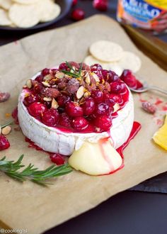 a cheese dish with cranberry sauce and nuts