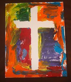 an art project with colorful paint and a cross painted on it