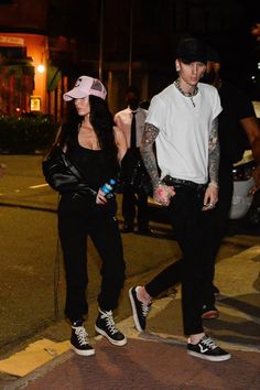 two people walking down the street at night