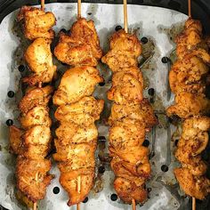 chicken skewers are being cooked on the grill