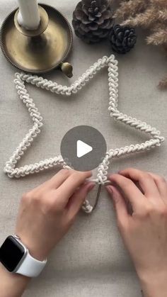 someone is making a snowflake out of rope