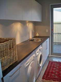 a washer and dryer in a small room next to a sliding glass door