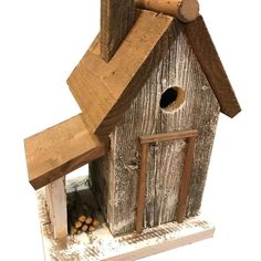 a bird house made out of wood and logs