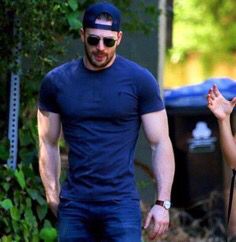 a man and woman walking down the street together, with one holding his hand out