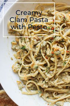 creamy clam pasta with pesto in a white bowl