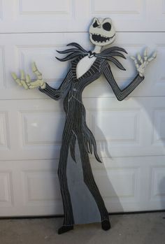 a skeleton standing in front of a garage door with his hands out to the side